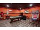 Game room featuring orange walls, TV, pool table and arcade games at 7541 Marker Ave, Kissimmee, FL 34747