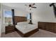 Serene primary bedroom boasting dark wood furniture, plush carpets, and ample natural light from large windows at 7541 Marker Ave, Kissimmee, FL 34747