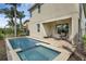 Backyard oasis with pool, spa, and covered patio seating area at 7541 Marker Ave, Kissimmee, FL 34747