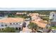 Aerial view of a town center with shops, restaurants, and golf cart parking surrounded by beautiful landscaping at 759 Largo Pass, Poinciana, FL 34759
