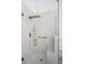 Modern shower features marble tile, a glass door, a bench, and rainfall shower head at 759 Largo Pass, Poinciana, FL 34759
