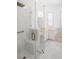 Bright bathroom with a glass enclosed shower, white vanity, gold fixtures, and soaking tub at 759 Largo Pass, Poinciana, FL 34759