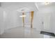 Clean entryway featuring modern lighting, bright white walls and tile floor, and an exterior door at 759 Largo Pass, Poinciana, FL 34759