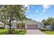 Charming single-story home with a well-manicured lawn, a brick driveway, and a two-car garage at 759 Largo Pass, Poinciana, FL 34759
