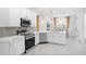 Elegant kitchen with white cabinets, stainless steel appliances, pendant lighting, and an open layout at 759 Largo Pass, Poinciana, FL 34759