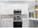 Contemporary kitchen showcasing white cabinetry, stainless steel appliances, and sleek countertops at 759 Largo Pass, Poinciana, FL 34759