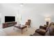 Comfortable living room features a leather sofa, area rug, and a large television at 759 Largo Pass, Poinciana, FL 34759