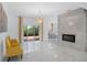 Open-concept living area features a modern fireplace and sliding glass doors leading to the patio at 759 Largo Pass, Poinciana, FL 34759