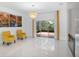 Spacious living area with a fireplace, bright armchairs, and access to the screened-in patio at 759 Largo Pass, Poinciana, FL 34759