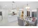 Bright, open-concept living space with modern kitchen, dining area, and sliding glass doors to outdoor patio at 759 Largo Pass, Poinciana, FL 34759