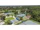 An aerial view showcases tennis courts, shuffleboard courts, and green spaces in a vibrant and active community at 759 Largo Pass, Poinciana, FL 34759