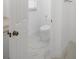 Clean and bright white toilet room with white marble-look tile floor at 759 Largo Pass, Poinciana, FL 34759