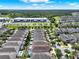 High aerial view of many houses with pools, and commercial area in the distance at 7613 Brookhurst Ln, Kissimmee, FL 34747