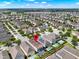 High aerial view of neighborhood with map pin pointing to subject property location at 7613 Brookhurst Ln, Kissimmee, FL 34747