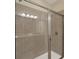 Bathroom shower with glass doors and gray tile in neutral contemporary space at 7613 Brookhurst Ln, Kissimmee, FL 34747