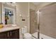 Bathroom with granite counters, dark wood cabinet, and a shower at 7613 Brookhurst Ln, Kissimmee, FL 34747