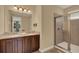 Bathroom featuring double sinks, granite countertops, and walk in shower at 7613 Brookhurst Ln, Kissimmee, FL 34747