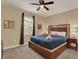 Bedroom featuring a ceiling fan, and a large bed with blue comforter and white linens at 7613 Brookhurst Ln, Kissimmee, FL 34747