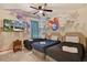 Stylish themed bedroom with three twin beds and whimsical wall art at 7613 Brookhurst Ln, Kissimmee, FL 34747