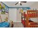 Fun ' bedroom with themed decor, bunk beds, and a flat-screen TV at 7613 Brookhurst Ln, Kissimmee, FL 34747