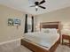 Comfortable bedroom featuring a ceiling fan, tv and a large bed with plush white linens at 7613 Brookhurst Ln, Kissimmee, FL 34747