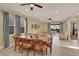 Elegant dining area with tile floors, decorative ceiling fans, and large windows with backyard views at 7613 Brookhurst Ln, Kissimmee, FL 34747