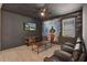 Entertainment room featuring movie style seating, a mural and light wood floors at 7613 Brookhurst Ln, Kissimmee, FL 34747