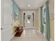 Inviting foyer with neutral tile floors, a striking accent wall, and bright, natural light at 7613 Brookhurst Ln, Kissimmee, FL 34747