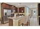 Well-equipped kitchen with stainless steel appliances, granite countertops, island with barstool seating at 7613 Brookhurst Ln, Kissimmee, FL 34747