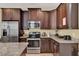 Well-equipped kitchen with stainless steel appliances, granite countertops, and ample cabinet space at 7613 Brookhurst Ln, Kissimmee, FL 34747