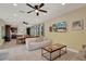 Living room featuring tile flooring, a ceiling fan and a dining area with a view to the kitchen at 7613 Brookhurst Ln, Kissimmee, FL 34747