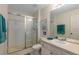 Bright bathroom with a glass shower door, white vanity, and coordinated teal towels for a clean, modern feel at 7751 Tosteth St, Kissimmee, FL 34747