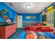 Fun ' bedroom with bright blue walls, red racecar beds, and playful decor at 7751 Tosteth St, Kissimmee, FL 34747