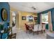 Bright dining room featuring an arched entry, tile floors, and a view into the living room at 7751 Tosteth St, Kissimmee, FL 34747