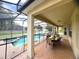 Spacious covered patio and screened-in pool, ideal for outdoor living and entertaining in any weather at 7751 Tosteth St, Kissimmee, FL 34747