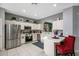 Modern kitchen featuring white cabinetry, stainless steel appliances, and an island with a breakfast bar at 7751 Tosteth St, Kissimmee, FL 34747