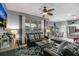 Comfortable living room featuring tile flooring, ceiling fan, large window and leather furniture at 7751 Tosteth St, Kissimmee, FL 34747