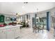 Open concept living space with views of the kitchen, dining area, and sliding glass doors leading to the pool area at 7751 Tosteth St, Kissimmee, FL 34747