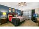 This spacious bedroom features a king-size bed, a crib, a ceiling fan and decorative touches, creating a cozy retreat at 7751 Tosteth St, Kissimmee, FL 34747