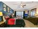 A spacious bedroom features a king-size bed, a crib, a ceiling fan and decorative touches, creating a cozy retreat at 7751 Tosteth St, Kissimmee, FL 34747