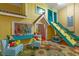 Fun playroom featuring a climbing wall, slide, and princess-themed playhouse at 7751 Tosteth St, Kissimmee, FL 34747