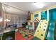 Spacious playroom with air hockey table, slides, and climbing wall for active fun at 7751 Tosteth St, Kissimmee, FL 34747