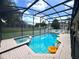 Relaxing screened-in pool and spa with sunny skies and comfortable lounge chairs, great for backyard fun at 7751 Tosteth St, Kissimmee, FL 34747
