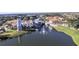 Aerial view of the community showcasing the lake with fountain and beautifully designed buildings at 777 Glendora Road, Poinciana, FL 34759