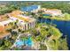 Aerial view of the community buildings, shimmering lakes, pools, and tropical foliage at 777 Glendora Road, Poinciana, FL 34759