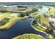 Aerial view of a stunning waterfront community with a lake, golf course, and picturesque walking trails at 777 Glendora Road, Poinciana, FL 34759