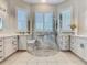 Luxurious bathroom with walk-in shower, white cabinets, and double sinks at 777 Glendora Road, Poinciana, FL 34759