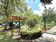 Charming community garden entrance with a welcoming sign, greenery, and a peaceful atmosphere at 777 Glendora Road, Poinciana, FL 34759