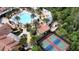 Aerial view of a luxurious community pool area with tennis and pickleball courts at 777 Glendora Road, Poinciana, FL 34759