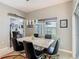 Bright dining area with marble table, modern lighting, and view to adjacent living area at 777 Glendora Road, Poinciana, FL 34759
